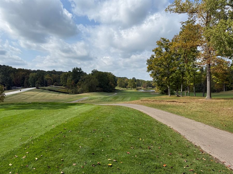 Tree-lined golf fairway in autumn